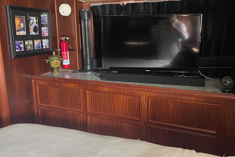 Slide: The Image of Interior of 1984 Hatteras 53 Yacht with TV, wood cabinets, and decor. - 40