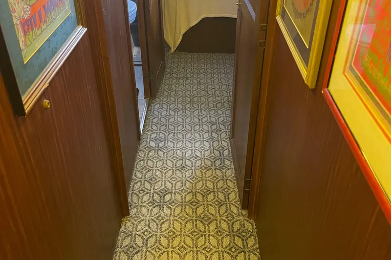 Slide: The Image of Hallway inside 1984 Hatteras 53 Extended Deckhouse Motor Yacht with patterned carpet and framed art. - 43