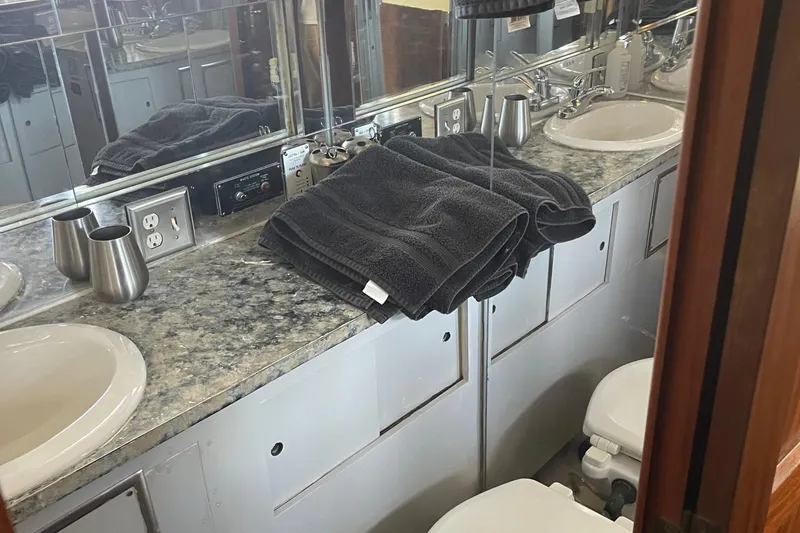 Slide: The Image of 1984 Hatteras 53 Motor Yacht bathroom with dual sinks and granite countertop. - 45