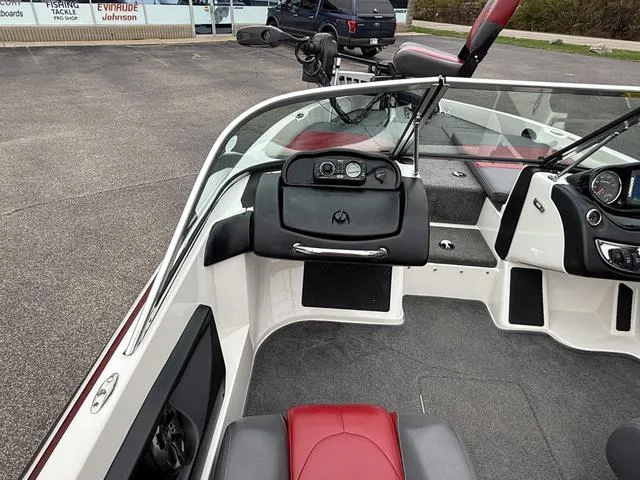 Slide: The Image of 2014 Triton 220 Escape boat interior with red and black seating, dashboard, and steering wheel. - 4