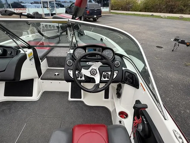 Slide: The Image of 2014 Triton 220 Escape boat interior with steering wheel and dashboard controls. - 5