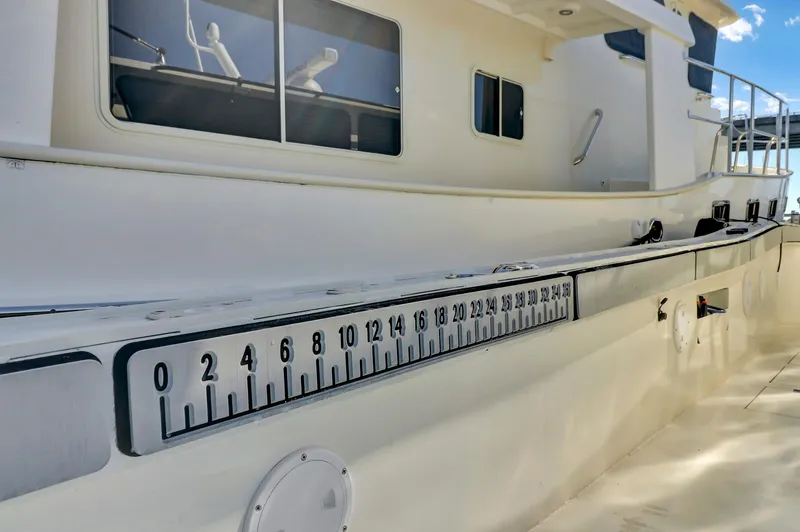 Slide: The Image of Custom Nerowalker 2024 boat with measurement scale on the side, docked under clear skies. - 11