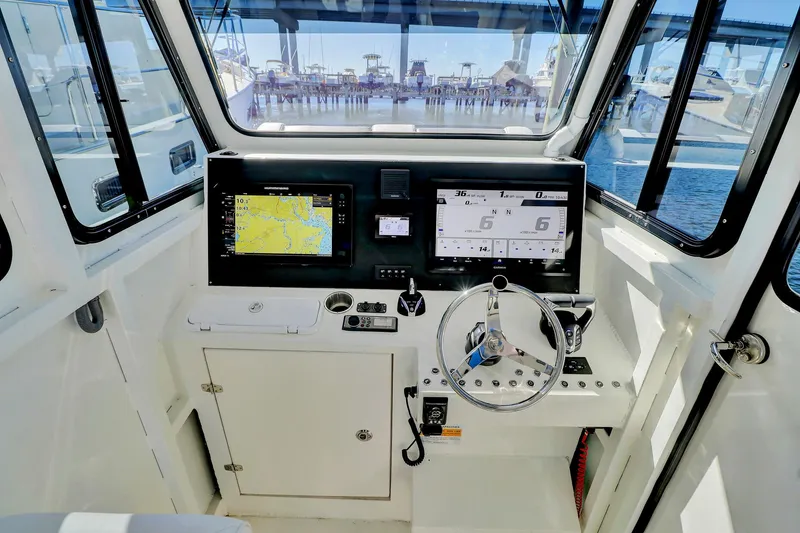 Slide: The Image of 2024 Custom Nerowalker boat cockpit with navigation screens and steering wheel. - 13