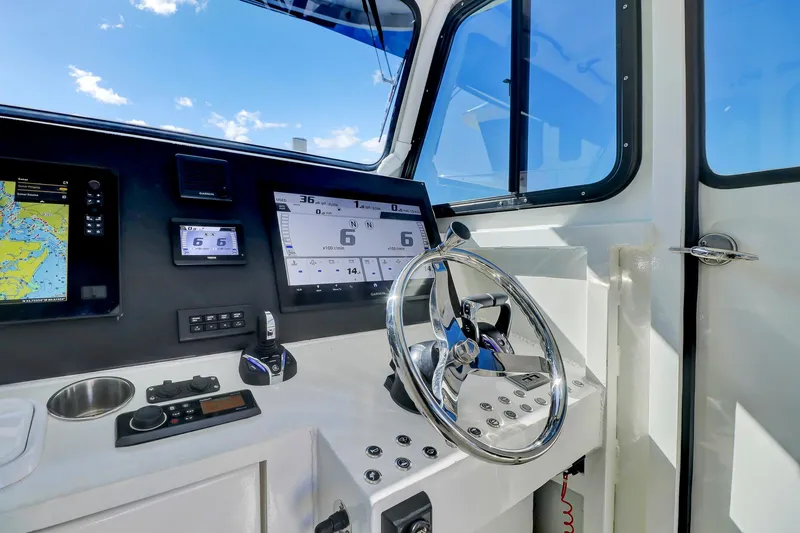 Slide: The Image of Control panel of 2024 Custom Nerowalker boat with steering wheel and navigation screens. - 14