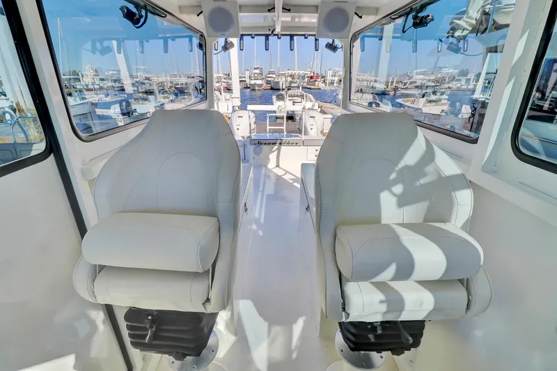 Slide: The Image of Interior of 2024 Custom Nerowalker boat with two white captain chairs. - 16