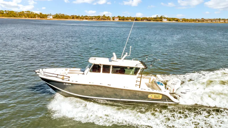 Slide: The Image of Custom Nerowalker 2024 boat cruising on a sunny day in open water. - 2