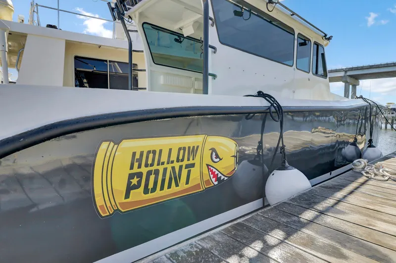 Slide: The Image of Custom Nerowalker 2024 boat docked, featuring "Hollow Point" logo on the side. - 5