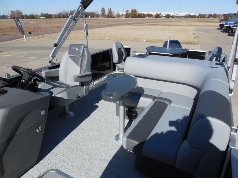 Slide: The Image of 2025 Bennington 23 SS pontoon boat interior with gray seating and steering console. - 6