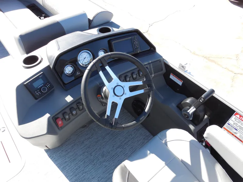 Slide: The Image of 2025 Bennington 23 SS boat dashboard with steering wheel and control panel. - 7