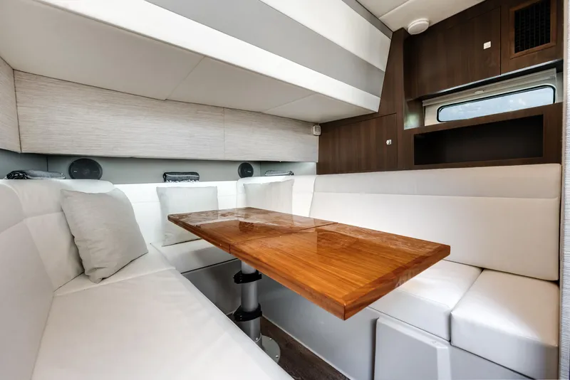 Slide: The Image of 2023 Cruisers Yachts 42 GLS OB interior with elegant seating and wooden table. - 11