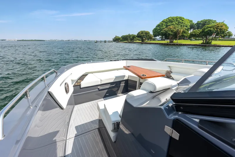 Slide: The Image of 2023 Cruisers Yachts 42 GLS OB on water, featuring sleek seating and scenic view. - 24