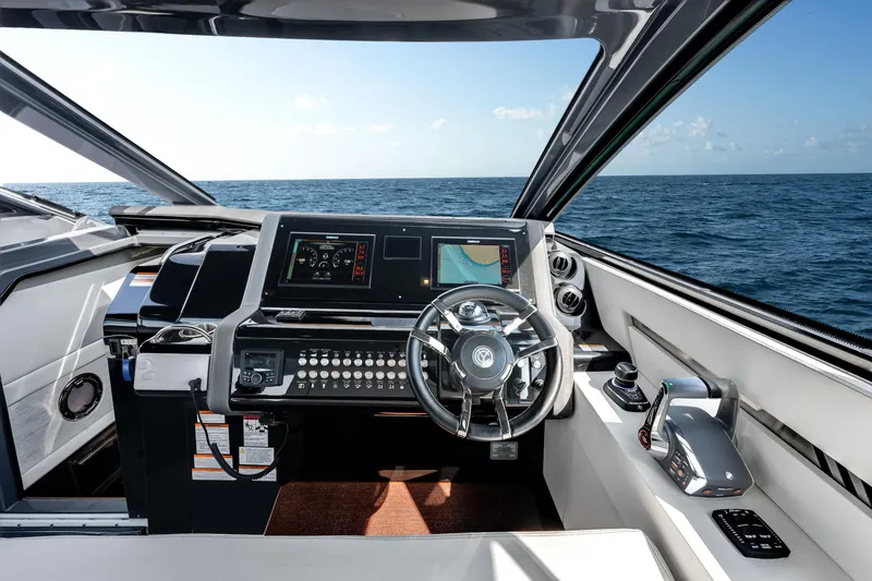 Slide: The Image of 2023 Cruisers Yachts 42 GLS OB helm with modern controls and ocean view. - 28