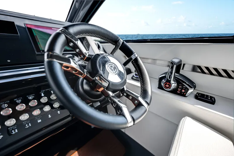 Slide: The Image of 2023 Cruisers Yachts 42 GLS OB helm with steering wheel and controls, ocean view. - 29