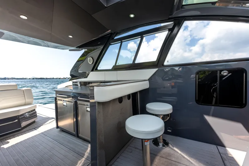 Slide: The Image of 2023 Cruisers Yachts 42 GLS OB interior with seating and ocean view. - 46