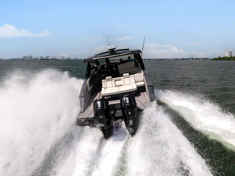 Slide: The Image of 2023 Cruisers Yachts 42 GLS OB speeding on open water, rear view. - 47