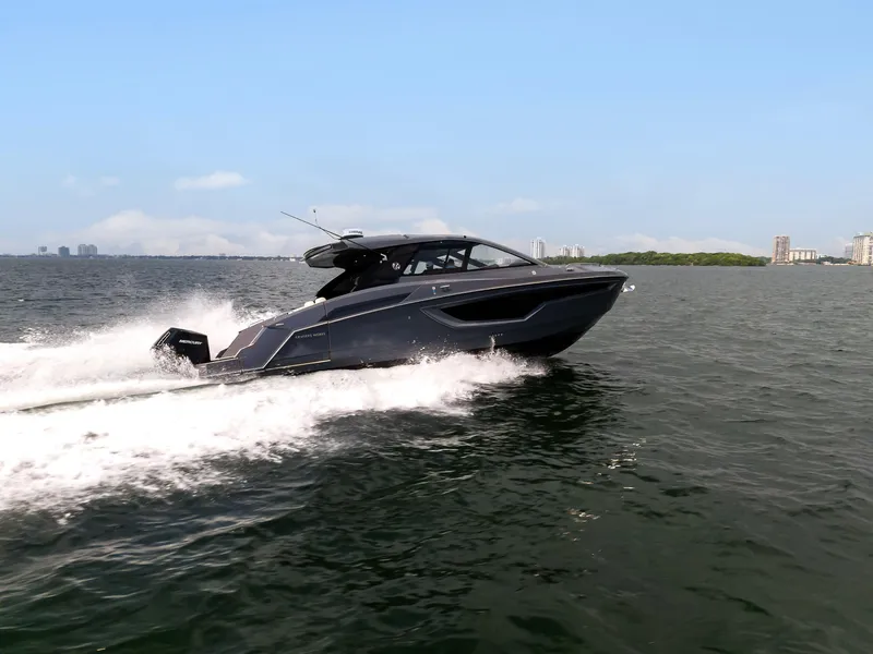 Slide: The Image of 2023 Cruisers Yachts 42 GLS OB speeding on open water under clear skies. - 6
