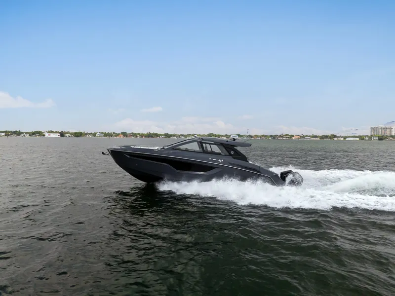 Slide: The Image of 2023 Cruisers Yachts 42 GLS OB speeding on open water under clear skies. - 7