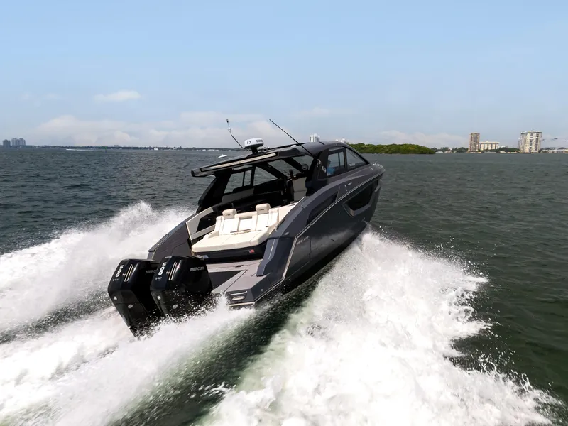 Slide: The Image of 2023 Cruisers Yachts 42 GLS OB speeding on water, showcasing sleek design and powerful engines. - 8