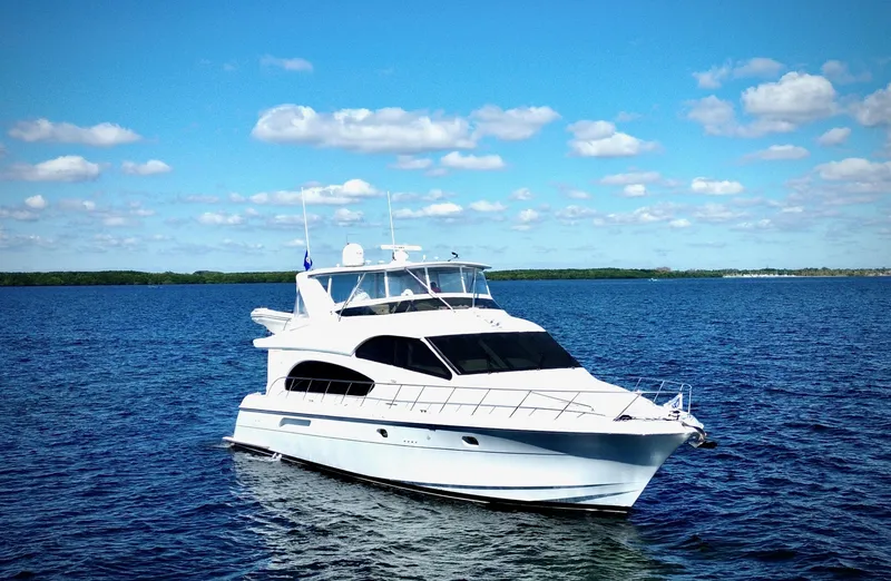 The Image of 2003 Hatteras 6300 Motor Yacht cruising on a sunny day with blue skies. - 0