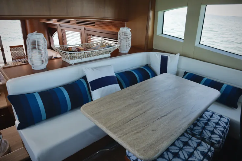 Slide: The Image of Interior of 2003 Hatteras 6300 Motor Yacht with elegant dining area and ocean view. - 12