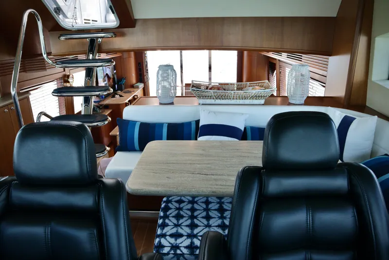 Slide: The Image of Interior of 2003 Hatteras 6300 Motor Yacht with modern seating and elegant decor. - 14
