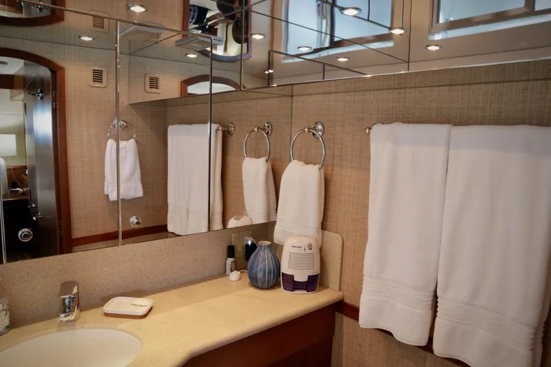 Slide: The Image of Luxurious bathroom in 2003 Hatteras 6300 Motor Yacht with elegant fixtures and towels. - 16