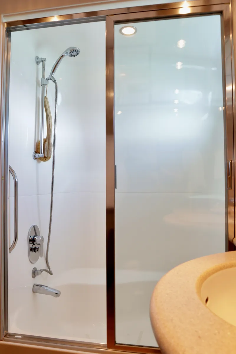 Slide: The Image of Shower area in 2003 Hatteras 6300 Motor Yacht with glass door and modern fixtures. - 17