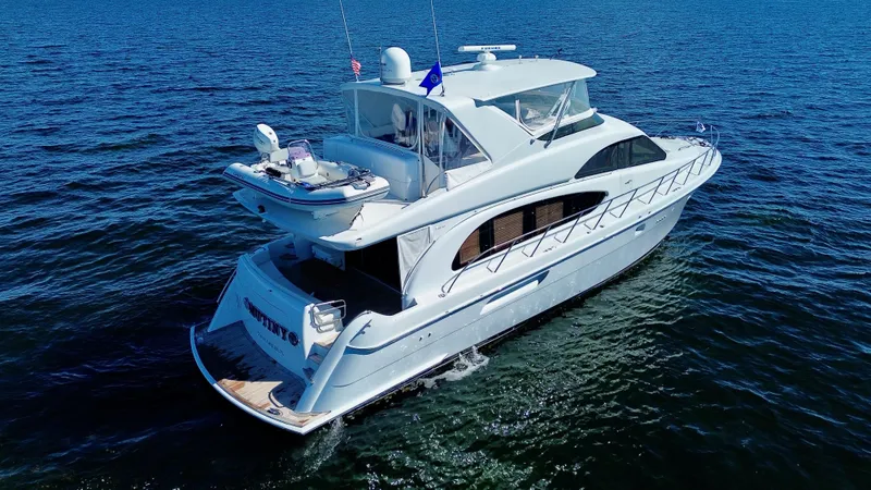Slide: The Image of 2003 Hatteras 6300 Motor Yacht cruising on open water. - 2