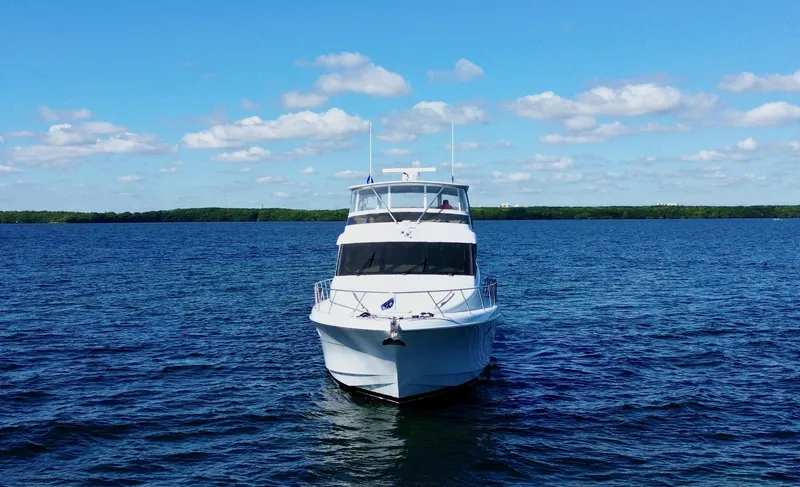 Slide: The Image of Hatteras 6300 Motor Yacht 2003 on calm blue water under a clear sky. - 3