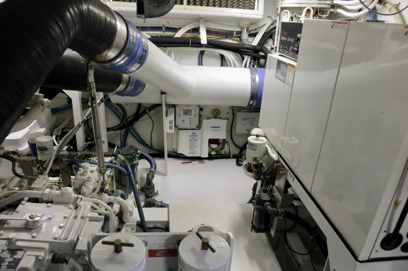Slide: The Image of Engine room of 2003 Hatteras 6300 Motor Yacht with visible machinery and piping. - 30
