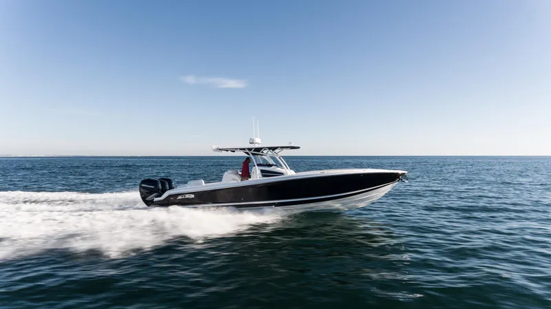 The Image of 2025 Nor-Tech 340 boat cruising on open water under clear blue sky. - 0