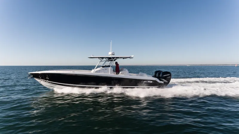 Slide: The Image of 2025 Nor-Tech 340 boat cruising on open water under clear skies. - 11