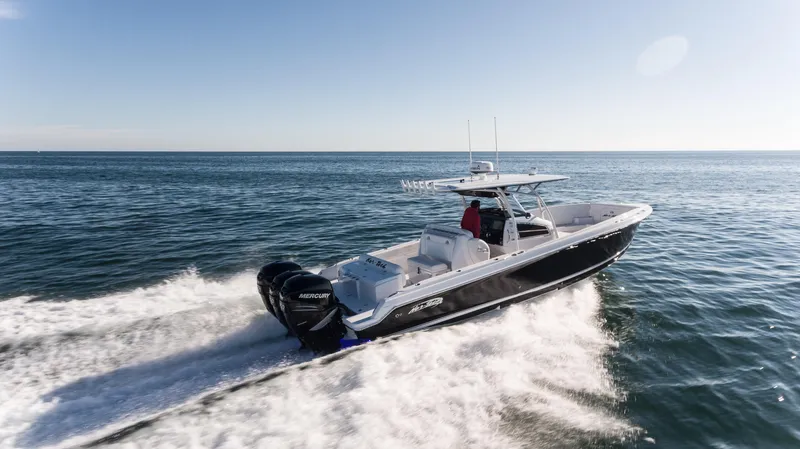 Slide: The Image of 2025 Nor-Tech 340 boat cruising on open water, showcasing sleek design and powerful engines. - 13