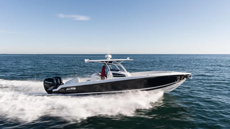 Slide: The Image of 2025 Nor-Tech 340 boat cruising on open water, side view. - 15