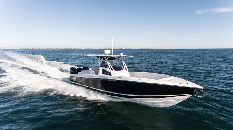 Slide: The Image of 2025 Nor-Tech 340 boat cruising on open water, showcasing sleek design and powerful performance. - 17