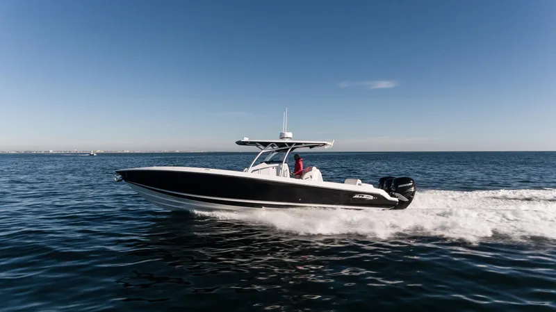 Slide: The Image of 2025 Nor-Tech 340 boat cruising on open water under clear blue sky. - 21