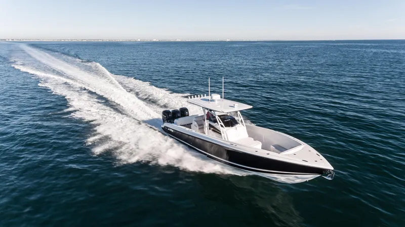 Slide: The Image of 2025 Nor-Tech 340 boat cruising on open water, showcasing sleek design and powerful performance. - 3