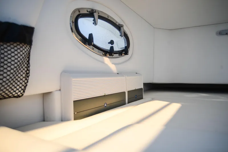 Slide: The Image of Interior cabin of 2025 Nor-Tech 340 boat with porthole window and storage. - 32