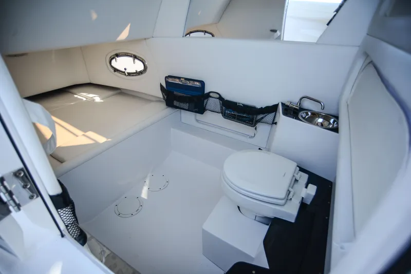 Slide: The Image of 2025 Nor-Tech 340 boat interior with toilet and storage compartments. - 35