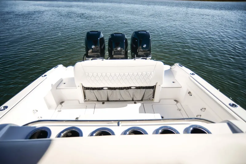 Slide: The Image of 2025 Nor-Tech 340 boat with triple engines on calm water. - 36