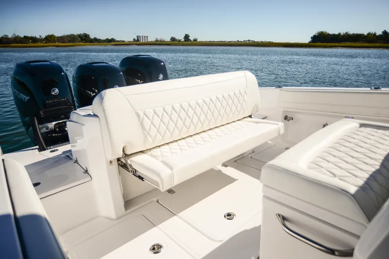 Slide: The Image of 2025 Nor-Tech 340 boat with luxurious white seating on a serene lake. - 39