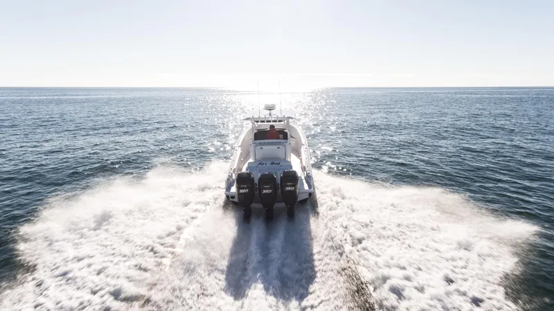 Slide: The Image of 2025 Nor-Tech 340 boat speeding on open water, creating a wake. - 4