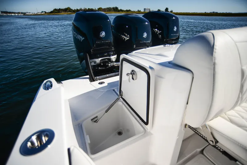 Slide: The Image of 2025 Nor-Tech 340 boat with triple Mercury engines on calm water. - 40