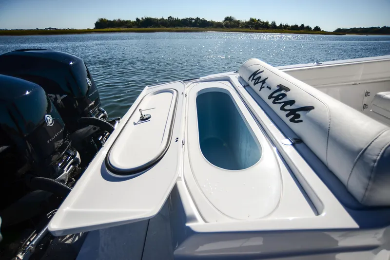 Slide: The Image of 2025 Nor-Tech 340 boat with open storage compartment on a sunny day. - 41
