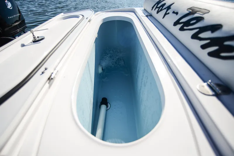 Slide: The Image of Nor-Tech 340 boat storage compartment, 2025 model, open on water. - 42