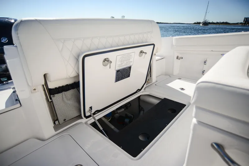 Slide: The Image of 2025 Nor-Tech 340 boat interior storage compartment open on deck. - 48