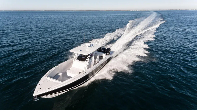 Slide: The Image of 2025 Nor-Tech 340 boat cruising on open water, leaving a wake behind. - 5