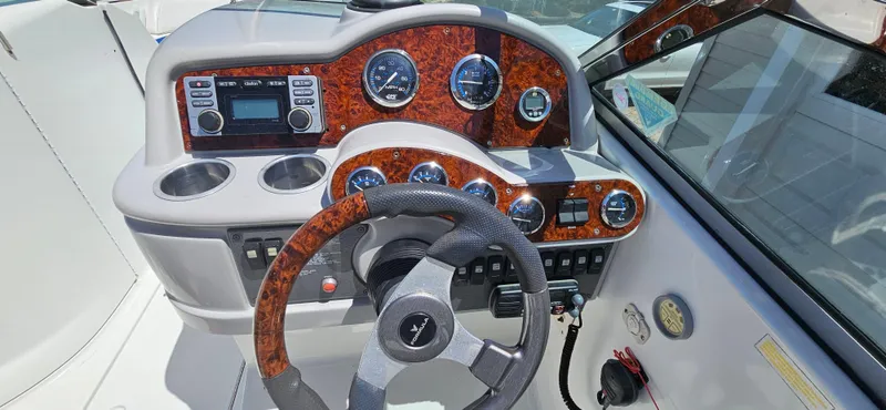 Slide: The Image of 2004 Formula 260 Bowrider dashboard with wood accents and steering wheel. - 10