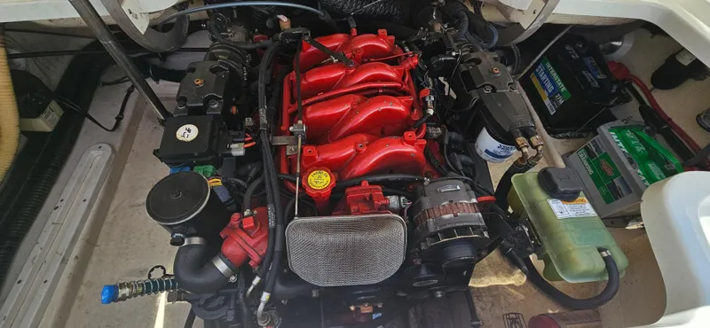 Slide: The Image of Engine compartment of a 2004 Formula 260 Bowrider boat, featuring a red engine. - 15