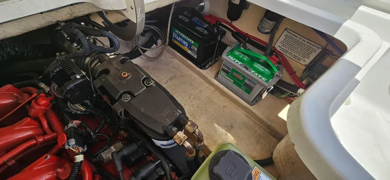Slide: The Image of Engine compartment of a 2004 Formula 260 Bowrider with visible batteries and wiring. - 16
